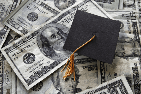 graduation cap with money in background